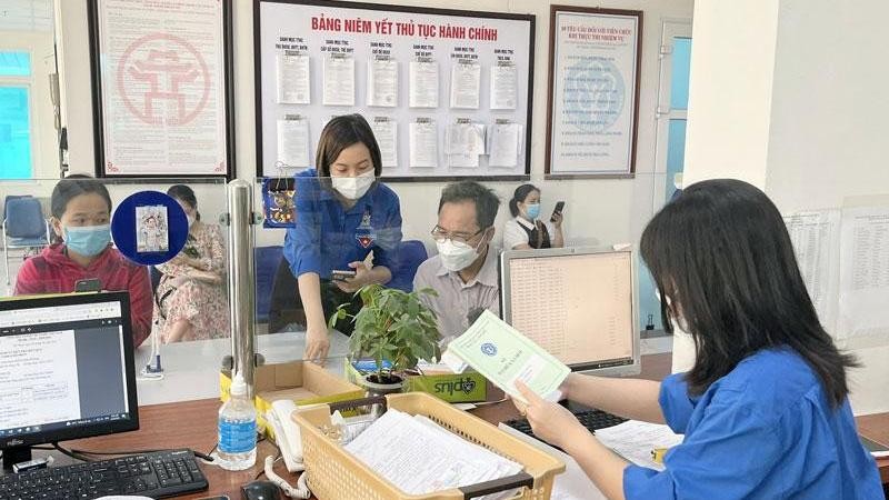 uổi trẻ Bảo hiểm xã hội quận Hà Đông (Hà Nội) hỗ trợ người dân làm thủ tục hành chính (Ảnh: nhandan.vn).
